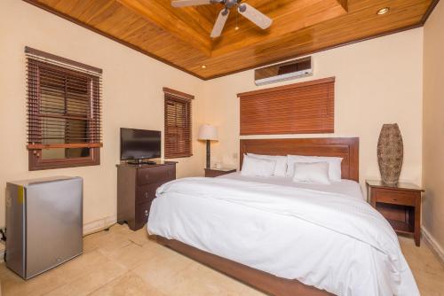 a bedroom with a bed and a ceiling fan at Jet Luxury at Langosta Beach Resort & Villas in Tamarindo