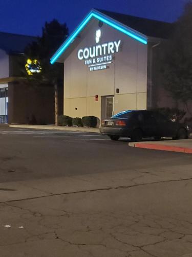a building with a car parked in front of it at Country Inn & Suites by Radisson, Bend, OR in Bend