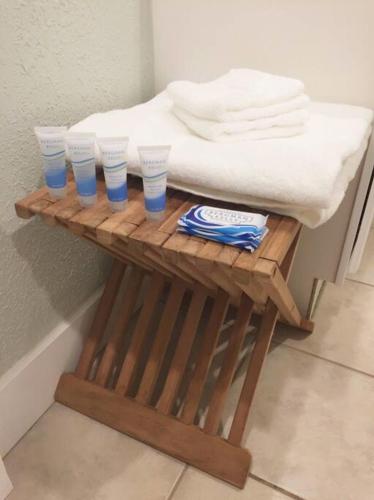 a wooden table with four blue cups on it at Light and Breezy in SoSo in West Palm Beach