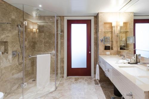 a bathroom with a shower and a glass door at Taj Hotel Cape Town - Taj Residence suites in Cape Town
