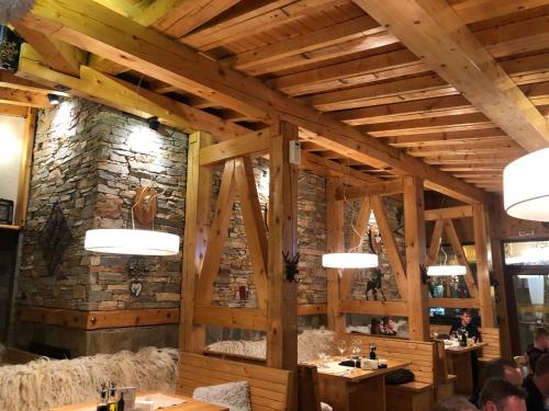 a dining room with a stone wall and wooden beams at Apartment 507 The Castle 1 in Pamporovo