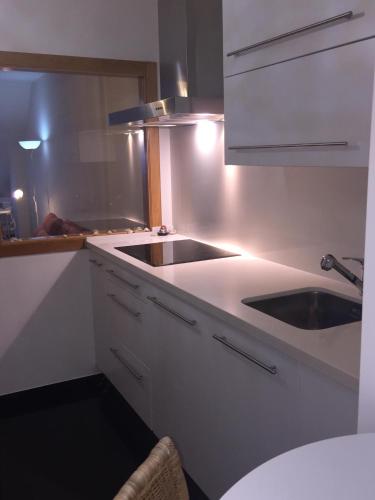 a kitchen with a sink and a counter top at Ático Masso in Cangas de Morrazo