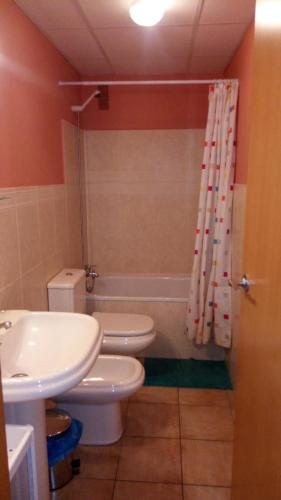 a bathroom with a toilet and a sink and a shower at Torrox Costa in Torrox Costa