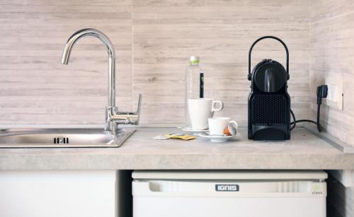 a kitchen counter with a sink and a coffee maker at CASAJULIENNE in Milan
