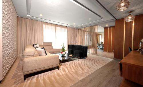 a living room with a couch and a television at Le Palace d'Anfa in Casablanca
