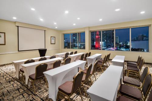 a conference room with tables and chairs and a whiteboard at Holiday Inn Hotel Port of Miami-Downtown by IHG in Miami