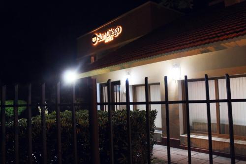 a sign on the side of a building at night at San Diego in La Falda