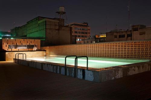 a swimming pool on top of a building at night at Downtown in Mexico City