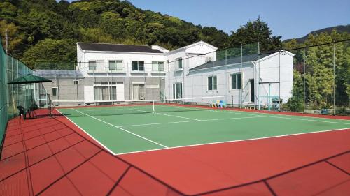 a tennis court in front of a house at Pension Rally / Vacation STAY 5731 in Kawazu