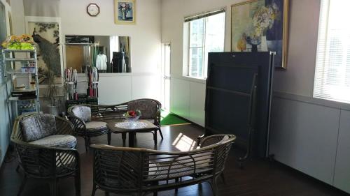 Habitación con sillas, mesa y nevera. en Pension Rally / Vacation STAY 5731, en Kawazu