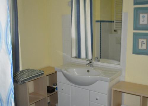 a white bathroom with a sink and a shower at Ferienwohnung Freiraumwohnung in Tessenow