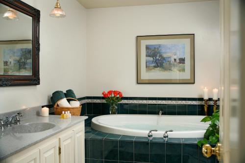 a bathroom with a bath tub and a sink at Chesterfield Inn in West Chesterfield