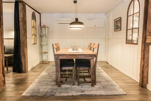 a wooden table and chairs in a room at Ladugårdens Pub & Sal in Enhörna