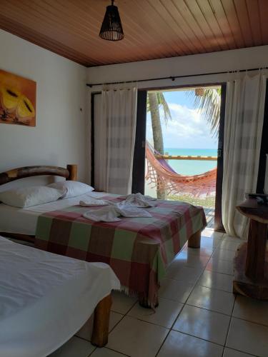 Ένα ή περισσότερα κρεβάτια σε δωμάτιο στο Pousada Enseada dos Saveiros