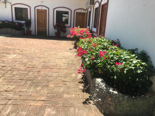 a brick walkway with flowers in front of a building at Casa Blue Tortuga in Ballenita