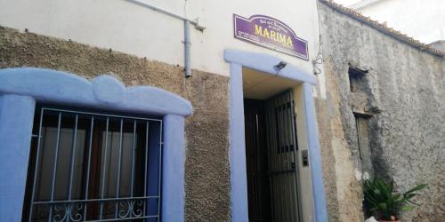 a building with a door and a sign on it at B & B MARIMA ORGOSOLO in Orgosolo