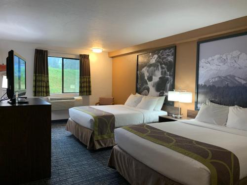 a hotel room with two beds and a television at Super 8 by Wyndham Port Angeles at Olympic National Park in Port Angeles