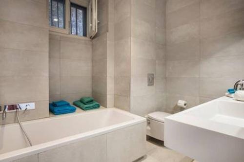 łazienka z wanną, toaletą i umywalką w obiekcie Palm Mansion w mieście Agia Efimia