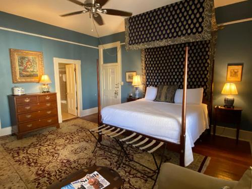 a bedroom with a bed and a dresser at Foley House Inn in Savannah