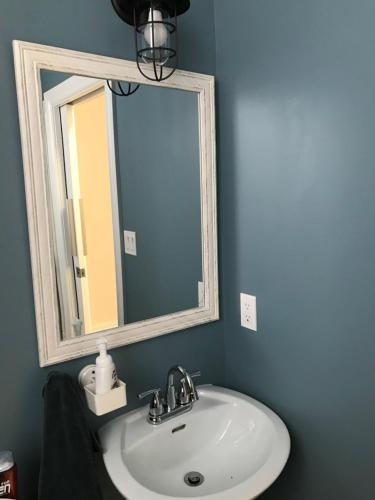 a bathroom with a white sink and a mirror at Pring Guesthouse in Hamilton