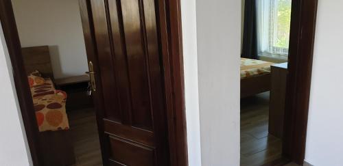 a door leading into a room with a bedroom at Casa de vacanta Spiritul Deltei in Sfântu Gheorghe