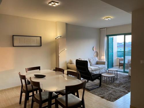 a living room with a table and a couch at Casa Toboso 2 in Torre del Mar