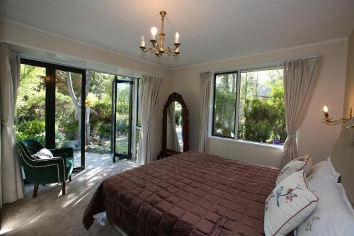 a bedroom with a bed and large windows at Star Dream Manor in Lake Tekapo