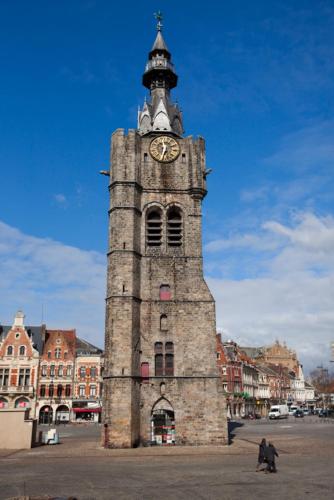 a tall tower with a clock on top of it at Studios Design by Les Béthunoises in Béthune