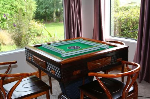 a desk with a game on it in front of a window at Star Dream Manor in Lake Tekapo