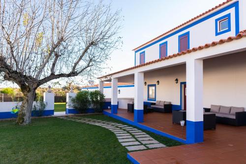 a house with blue and white walls and a yard at Tapada do Chafariz in Estremoz