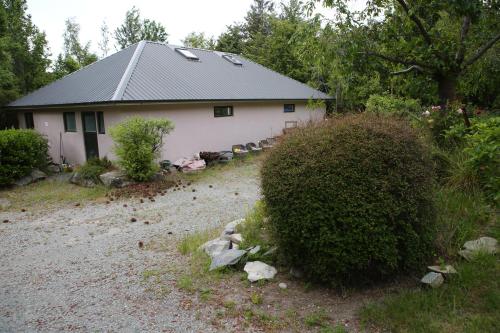 a house with a gravel driveway in front of it at Star Dream Manor in Lake Tekapo
