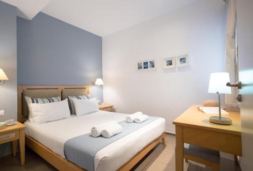 a bedroom with a bed with towels on it at Anna Plakias Apartments in Plakias