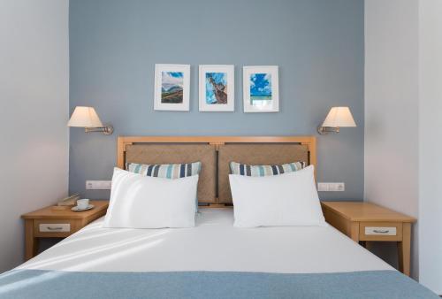 a bedroom with a large bed with two pillows at Anna Plakias Apartments in Plakias
