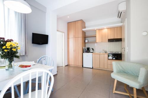 a kitchen and dining room with a table and chairs at Anna Plakias Apartments in Plakias