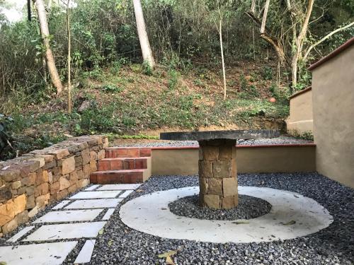 a stone bench sitting in the middle of a patio at Hotel Casas de Campo El Ciruelo in San Gil