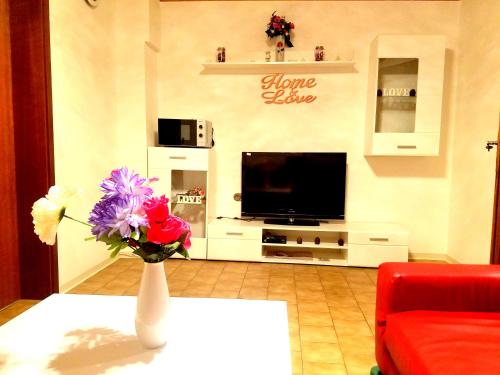 a living room with a vase of flowers on a table at Ferienwohnung in Friedberg (Hessen) für 1 bis 4 Personen in Friedberg