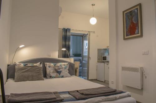a bedroom with a bed and a living room at Lux Apartment in Belgrade 2 in Belgrade