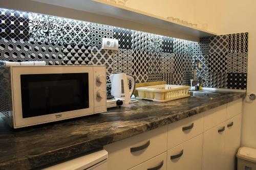 a kitchen counter with a microwave and a sink at Lux Apartment in Belgrade 2 in Belgrade