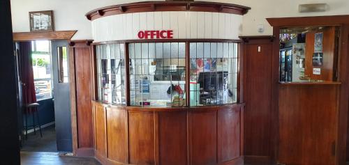 an entrance to a coffee shop with a glass window at Hotel Motueka Backpackers, Loud Live Music Friday Saturday Nights in Motueka