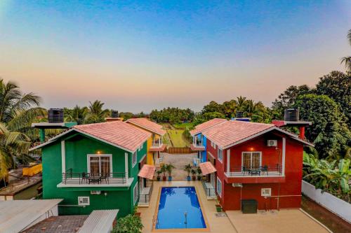 an aerial view of a home with colorful houses at Ludo Private Pool Villa, WiFi-Caretaker-Parking, North Goa in Baga