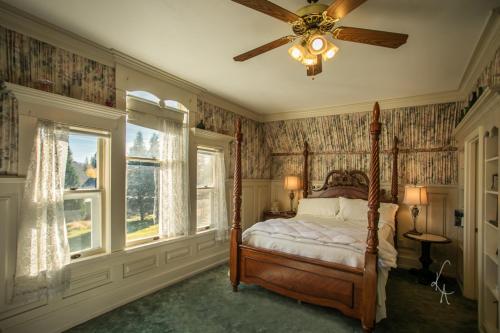 a bedroom with a bed and a ceiling fan at McCloud River Bed and Breakfast in McCloud