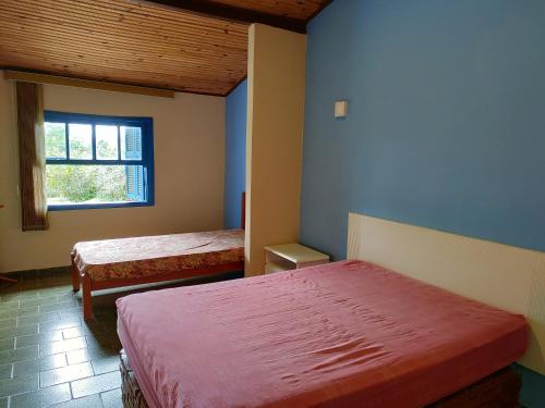 A bed or beds in a room at Recanto do Luar