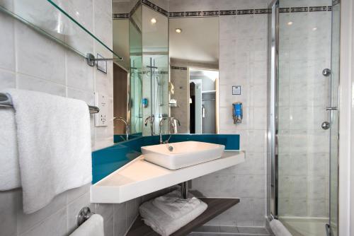 a bathroom with a sink and a shower at Holiday Inn Express London Greenwich, an IHG Hotel in London