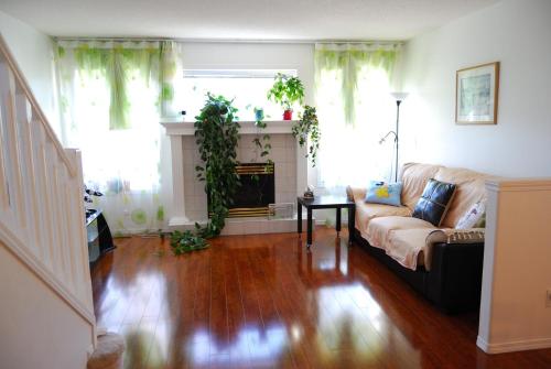 a living room with a couch and a fireplace at Hidden valley treehouse home! in Calgary