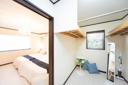 a bedroom with a bed and a mirror at Awaji Central Inn Kuruma713 in Awaji