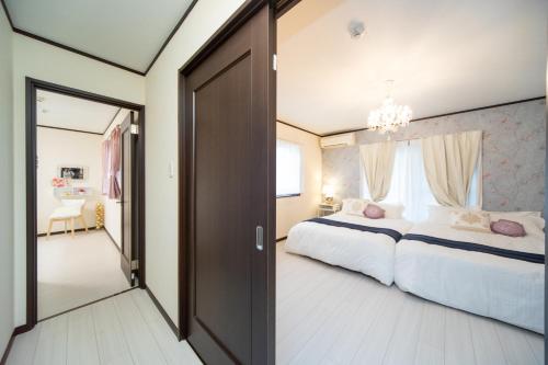 a bedroom with a large bed and a large window at Awaji Central Inn Kuruma713 in Awaji