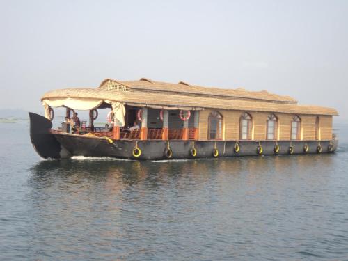 a large ferry boat on the water at Sreekrishna Houseboat in Kumarakom