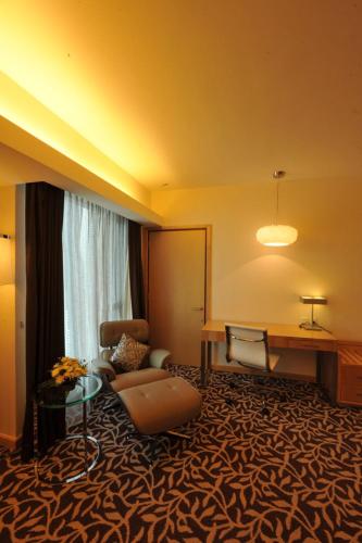 a hotel room with a couch and a table at The Everly Putrajaya in Putrajaya