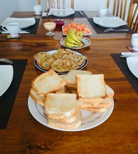 a table with two plates of food on a table at New Royal Mount Hotel in Nuwara Eliya