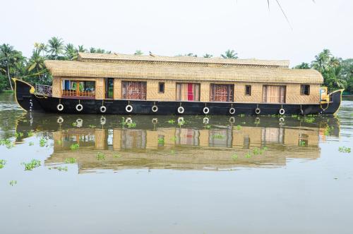 a boat in the water with a house on it at Sreekrishna Houseboat in Kumarakom